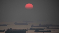 The sun sets past anchored barges ahead of the expected landfall of Super Typhoon Man-yi, in Manila Bay on November 16, 2024. A super typhoon sweeping towards the Philippines on November 16 was intensifying and could have a 