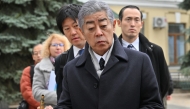 Japan's Foreign Minister Takeshi Iwaya (C) holds a cartridge sold by volunteers to raise money for the needs of Ukrainian army, as he visits the Saint Michael's Cathedral in Kyiv, on November 16, 2024. Photo by Sergei SUPINSKY / AFP.