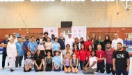 QGF President Ali Al Hitmi poses for a group photo with participating coaches and gymnasts. 