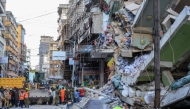 Emergency crews and first responders gather for rescue operations at the site of a collapsed four-story building in Dar es Salaam on November 16, 2024. (Photo by Gidulaus Amosi / AFP)