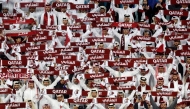 Qatar's fans cheer during the Qatar 2023 AFC Asian Cup semi-final match between Iran and Qatar at al-Thumama Stadium on February 7, 2024. Photo by KARIM JAAFAR / AFP

