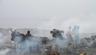 Farmers load sugarcane on a horsecart amid heavy smoggy conditions in Lahore on November 17, 2024. (Photo by Arif Ali / AFP)