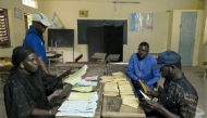 Election officials count ballots, as part of the parliamentary elections, at a voting center in Diamalaye, a neighborhood in Dakar on November 17, 2024. (Photo by Seyllou / AFP)