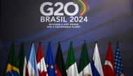 (L-R) National flags of Brazil, South Africa, Argentina, Canada, the European Union, Germany, Italy, Mexico, Russia, Turkiye, and the United States are seen at the media center in the MAM Modern Art Museum ahead of the G20 Summit in Rio de Janeiro, Brazil, on November 17, 2024. (Photo by Luis Robayo / AFP)