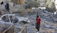 A boy walks on the rubble of a house destroyed in an Israeli strike on al-Jalaa street in central Gaza City on November 18, 2024. Photo by Omar AL-QATTAA / AFP