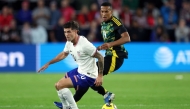 Christian Pulisic #10 of the United States and Isaac Hayden #14 of Jamaica compete for the ball during the 2024 Concacaf Nations League quarterfinal match at Citypark on November 18, 2024 in St Louis, Missouri. Jamie Squire/Getty Images/AFP