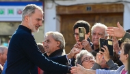 Spain's King Felipe VI greets residents during a visit to the flood damaged town of Chiva, in the region of Valencia, eastern Spain, in the aftermath of catastrophic deadly floods, on November 19, 2024. Photo by JOSE JORDAN / AFP