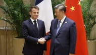 France's President Emmanuel Macron (L) shakes hands with China's President Xi Jinping during a bilateral meeting on the sidelines of the G20 summit in Rio de Janeiro, Brazil, on November 19, 2024. Photo by Ludovic MARIN / AFP.