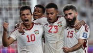 UAE's forward #10 Fabio de Lima celebrates with teammates after scoring a goal during the FIFA World Cup 2026 Asia zone qualifiers group A football match between UAE and Qatar at the Al-Nahyan Stadium in Abu Dhabi on November 19, 2024. (Photo by Fadel Senna / AFP)