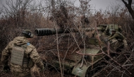 Ukrainian servicemen of the 24th Mechanized Brigade camouflage a 2s5 152 mm self-propelled howitzer at an undisclosed location near Chasiv Yar in Donetsk region on November 18, 2024. (Photo by Handout / 24th Mechanized Brigade of Ukrainian Armed Forces / AFP) 