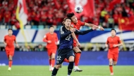 China's Lin Liangming (2R) fights for the ball with Japan's Ayumu Seko (C) during the 2026 FIFA World Cup qualification football match between China and Japan in Xiamen, in southeastern China's Fujian province on November 19, 2024. Photo by STRINGER / AFP.