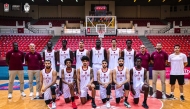 Qatar basketball team players and officials pose for a photo.