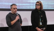 US film director Joel Souza (L) and cinematographer Bianca Cline (R) stand on stage before the first screening of the 