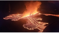 Handout picture released on November 21, 2024 by the Public Defense Department of the State Police Commissioner in Iceland shows Lava and smoke erupting from a volcano near Grindavik on the Icelandic peninsula of Reykjanes. (Photo by Public Defense Department of the State Police / AFP) 
