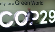 Attendees walk past the COP29 logo during the United Nations Climate Change Conference (Cop29) in Baku, Azerbaijan, on November 21, 2024. (Photo by STRINGER / AFP)

