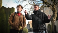 Invisible Cities guide Sonny Murray (R) leads a walking tour with student Arthur Lyhne-Gold, in Cannongate Kirk, Edinburgh, on November 17, 2024. (Photo by Andy Buchanan / AFP)