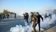 Policemen fire tear gas shells to disperse supporters of Pakistan Tehreek-e-Insaf (PTI) party during a protest to demand the release of former prime minister Imran Khan, in Islamabad on November 26, 2024. (Photo by Aamir Qureshi / AFP)