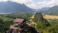 Tourists look at the surroundings from Namxay Viewpoint in Vang Vieng on November 24, 2024. Photo by AFP