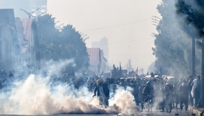 Policemen fire tear gas shells to disperse supporters of the Pakistan Tehreek-e-Insaf (PTI) party during a protest demanding the release of former prime minister Imran Khan, at the Red Zone area in Islamabad on November 26, 2024. (Photo by Aamir Qureshi / AFP)