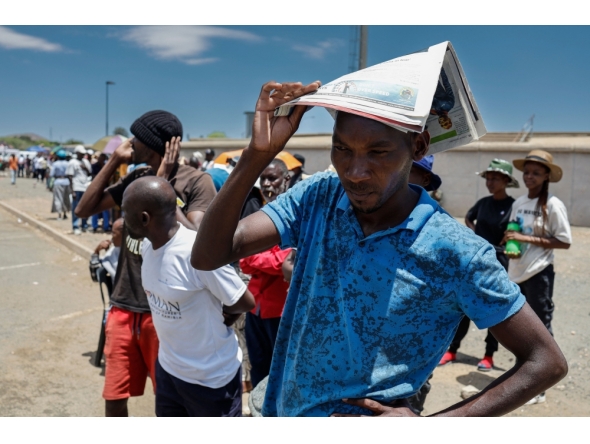 Voters queue at a polling station at the Sam Nujoma stadium in Windhoek on November 27, 2024 during Namibia's general election. (Photo by Simon Maina / AFP)