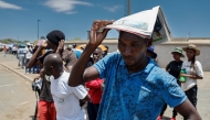 Voters queue at a polling station at the Sam Nujoma stadium in Windhoek on November 27, 2024 during Namibia's general election. (Photo by Simon Maina / AFP)