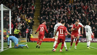 Liverpool's Dutch striker #18 Cody Gakpo (2R) celebrates scoring the team's second goal during the UEFA Champions League football match between Liverpool and Real Madrid at Anfield in Liverpool, north west England on November 27, 2024. (Photo by Oli SCARFF / AFP)
