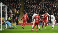 Liverpool's Dutch striker #18 Cody Gakpo (2R) celebrates scoring the team's second goal during the UEFA Champions League football match between Liverpool and Real Madrid at Anfield in Liverpool, north west England on November 27, 2024. (Photo by Oli SCARFF / AFP)
