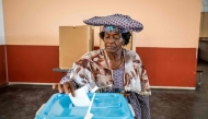 A woman casts her vote at a polling station in Windhoek on November 29, 2024, during extended voting following the country's general election. (Photo by Simon Maina / AFP)