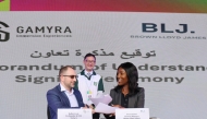 Raffat Zreik (left), Co-founder and CEO of Gamyra and Iman Asante, General Manager, BLJ Worldwide sign the MoU during QSTP AI Week 2024