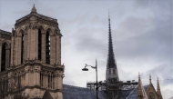 A construction worker walks on scaffoldings on the roof of Notre-Dame de Paris cathedral, a few days before its reopening in Paris, on December 2, 2024. (Photo by Dimitar Dilkoff / AFP)