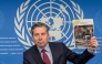 Humanitarian Affairs and Emergency Relief Coordinator (OCHA) Under-Secretary-General Tom Fletcher holds the Global Humanitarian Overwiew 2025 report during a press conference in Geneva on December 3, 2024. Photo by Elodie LE MAOU / AFP.
