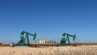 Pump jacks and storage tanks in the Permian Basin in western Texas.