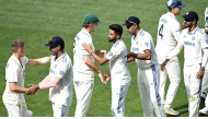 Indian and Australian players shake hands after the second Test match in Adelaide.