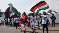 Supporters of Ghana's President and presidential candidate of the National Democratic Congress (NDC) party, John Mahama, celebrate after the opposition candidate, Ghana's Vice President and ruling New Patriotic Party (NPP) presidential candidate Mahamudu Bawumia, conceded defeat of the 2024 presidential election, in Accra on December 8, 2024. (Photo by Nipah Dennis / AFP)