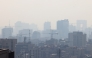 Smog covers Tehran on December 7, 2024 amid severe air pollution. Photo by ATTA KENARE / AFP.
