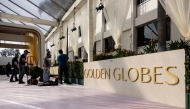 Workers display hedges by the red carpet as technicians and workers add the last touches the day before the Golden Globes at Beverly Hilton in Beverly Hills, California, on January 4, 2025. (Photo by Etienne Laurent / AFP)