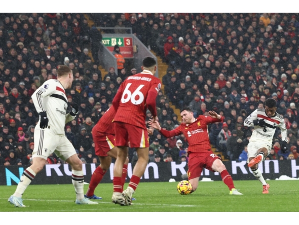 Manchester United's Ivorian midfielder #16 Amad Diallo (R) shoots to score their second goal during the English Premier League football match between Liverpool and Manchester United at Anfield in Liverpool, north west England on January 5, 2025. (Photo by Darren Staples / AFP) 