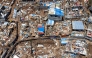 Files: This aerial view shows destroyed shelters and houses in the town of Vahibe, on the outskirts of Mamoudzou, on the French Indian Ocean territory of Mayotte, on December 24, 2024. (Photo by Patrick Meinhardt / AFP) 