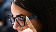 An attendee wears the Amazon Echo Frames smart glasses with Alexa during the Consumer Electronics Show (CES) in Las Vegas, Nevada on January 7, 2025. (Photo by Patrick T. Fallon / AFP)