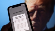 This illustration photo taken in Los Angeles on January 18, 2025, shows the TikTok app on a smartphone screen in front of a photo of US President-elect Donald Trump. Photo by Chris Delmas/ AFP