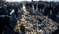 Mourners leave flowers and candles at the memorial site outside the adult education center Campus Risbergska school in Orebro, Sweden, on February 6, 2025 two days after a shooting there left eleven people dead. Photo by Christine Olsson/TT / TT NEWS AGENCY / AFP