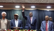 Abdul Rahim Hamdan Dagalo (C), Sudan's Rapid Support Forces (RSF) deputy commander and brother to Mohamed Hamdan Dagalo (also known as Hemedti), flanked by representatives of other political parties affiliated to Sudan's Rapid Support Forces react as they arrive at the venue ahead of their planned signing of the Government of Peace and Unity Charter, at the Kenyatta International Convention Centre (KICC) in Nairobi on February 18, 2025. (Photo by SIMON MAINA / AFP)