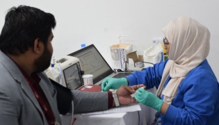 A staff member donates blood during the campaign recently.