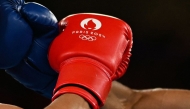 File: Kyrgyzstan's Munarbek Seiitbek Uulu and Bulgaria's Javier Ibanez Diaz (blue) competed in the men's 57kg semi-final boxing match during the Paris 2024 Olympic Games at the Roland-Garros Stadium, in Paris on August 8, 2024. (Photo by Mauro Pimentel / AFP)