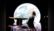 This undated image released by Firefly Aerospace Blue Ghost captures Earth reflecting off the solar panel with the Moon on the horizon. (Photo by Handout / Firefly Aerospace / AFP) 