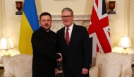 Britain's Prime Minister Keir Starmer shakes hands with Ukraine's President Volodymyr Zelensky during a bilateral meeting in central London on March 1, 2025 ahead of a European leader's summit the following day. (Photo by Peter Nicholls / POOL / AFP)
