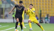 Al Sadd’s Boualem Khoukhi (left) in action against Al Wasl’s Ali Saleh during the match.