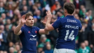 France's scrum-half Antoine Dupont (L) celebrates with France's wing Damian Penaud (R) but his try is disallowed for a knock-on in the build-up during the Six Nations international rugby union match between Ireland and France at the Aviva Stadium in Dublin, on March 8, 2025. (Photo by Paul Faith / AFP)