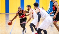 Al Rayyan's Darius Tyran Clark (left) dribbles. 