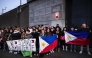 Protesters holding Filipino flags and a banner in support of former Philippine President Rodrigo Duterte gather outside the The Hague Penitentiary Institution prison, which houses the International Criminal Court's (ICC) detention unit, on March 12, 2025. (Photo by Ramon van Flymen / ANP / AFP)
